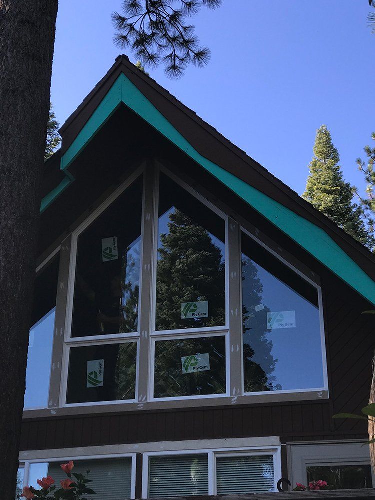 A house with a green roof and a lot of windows