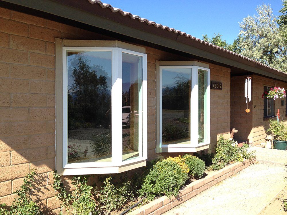 A house with two bay windows on the front of it