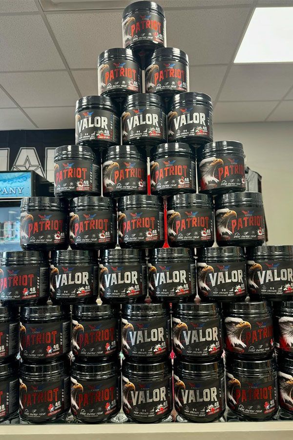 A stack of jars with the word valor on them are sitting on a shelf.