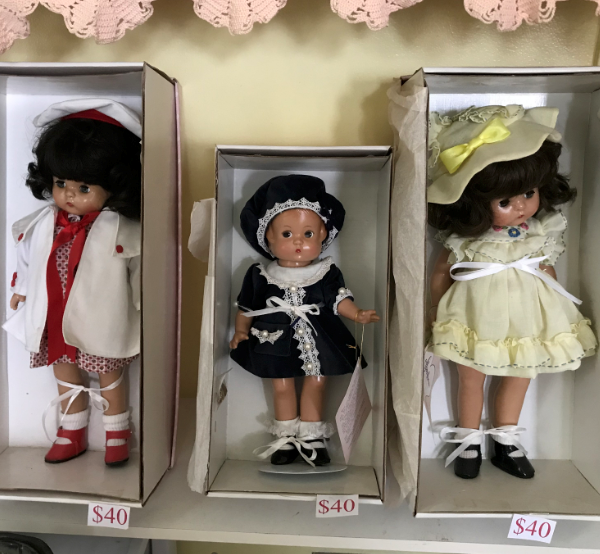 3 dolls in boxes with pricing