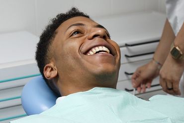 Laughing man sitting in dentist chair