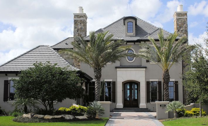 A large house with palm trees in front of it