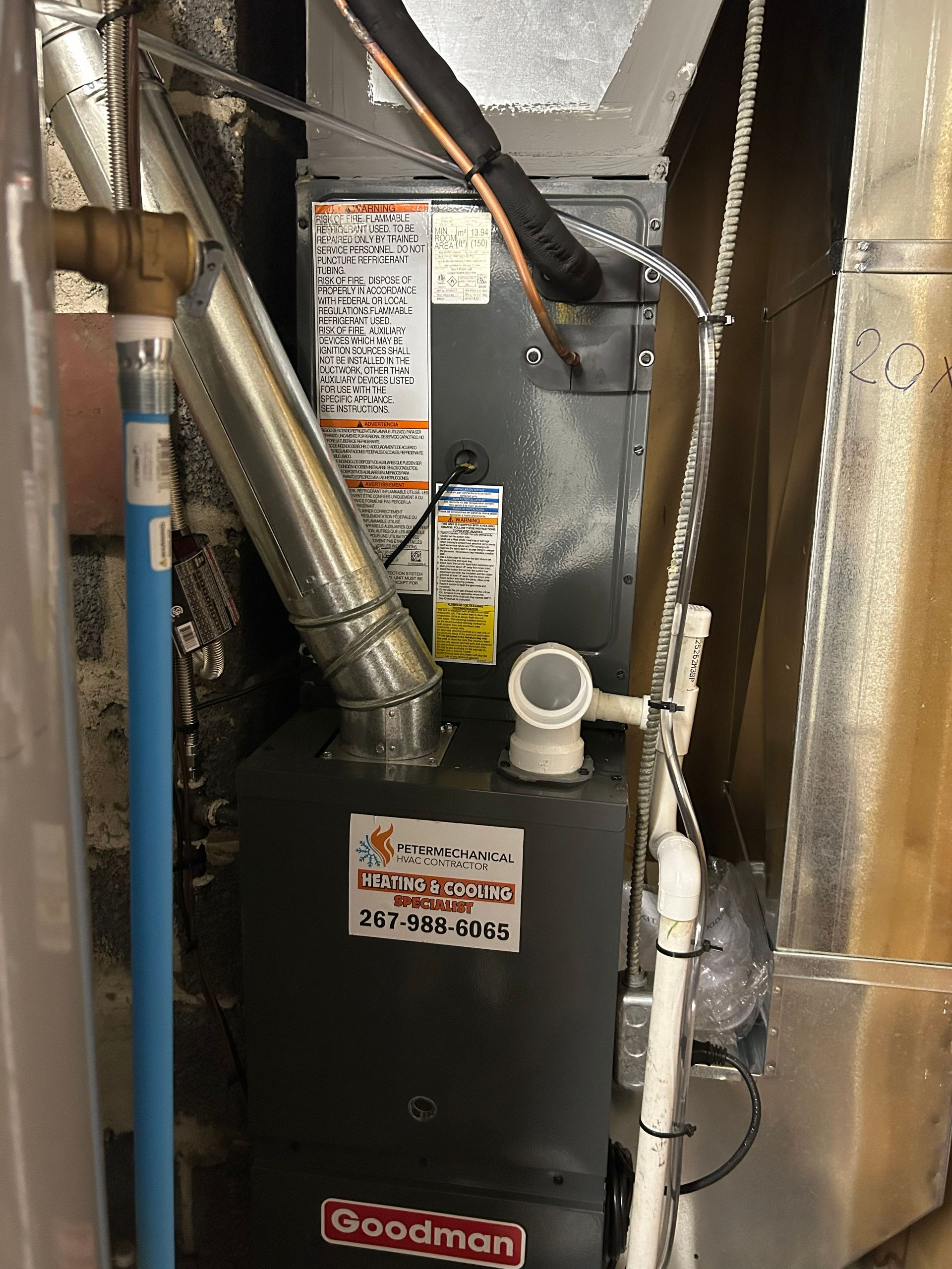 HVAC furnace with ductwork and wiring inside a narrow utility closet