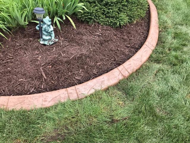 there is a statue of a gnome in the middle of the garden .