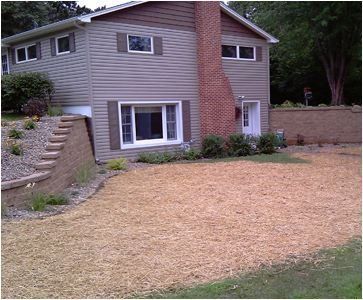 a house with a lot of gravel in front of it