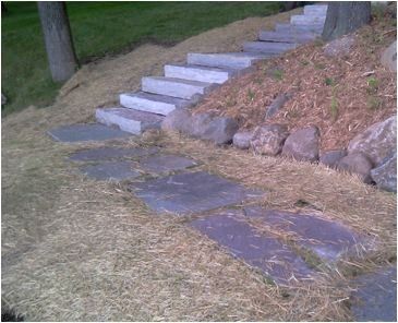 a set of stairs leading up to a grassy hillside