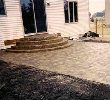 a house with a patio and stairs in front of it