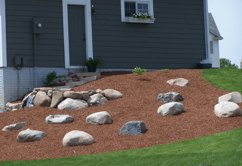 a house with a lot of rocks in front of it .