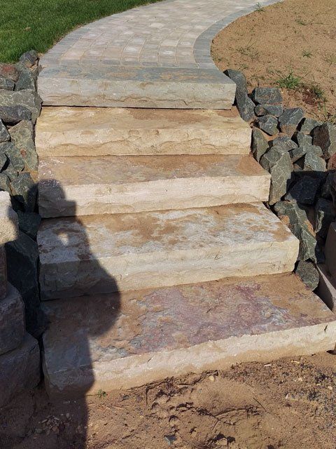 a set of stone stairs leading up to a stone walkway .