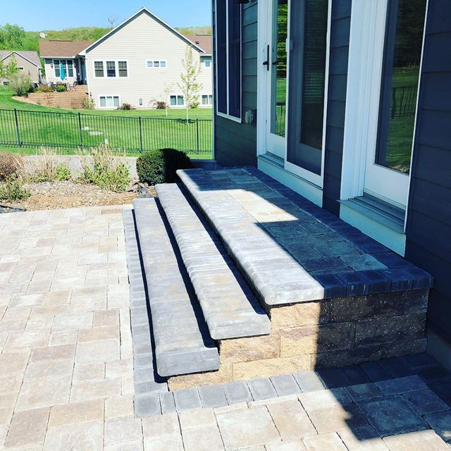 steps leading up to a house with a house in the background