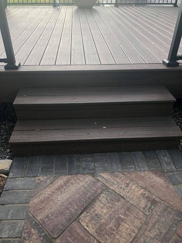 a wooden deck with stairs leading up to it .