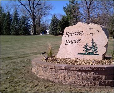 a large rock with the words fairway estates on it