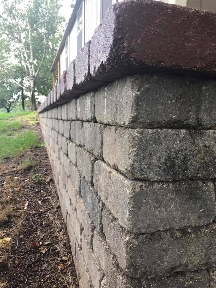 a close up of a brick wall next to a house .