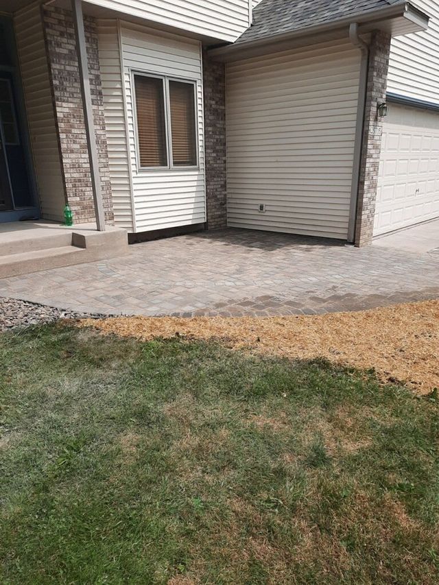 a house with a garage and a driveway in front of it .