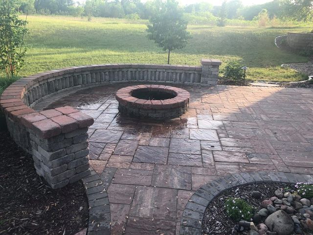 there is a fire pit in the middle of the patio .
