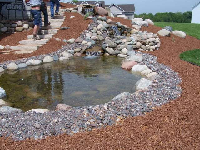 a small pond surrounded by rocks and gravel