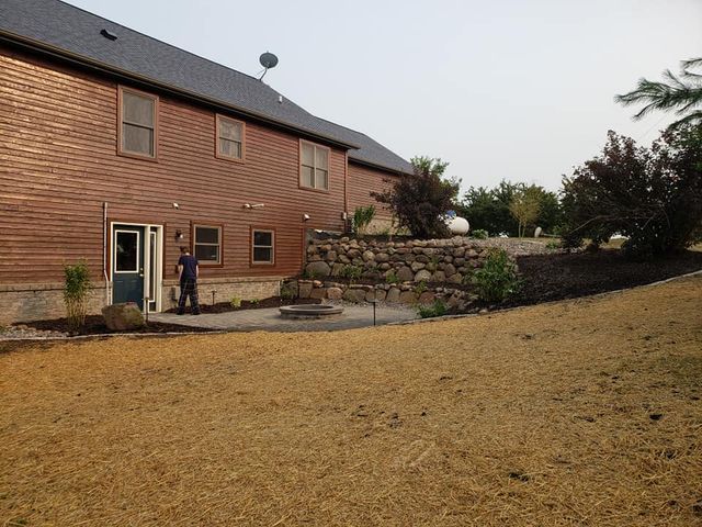a man is standing in front of a large house