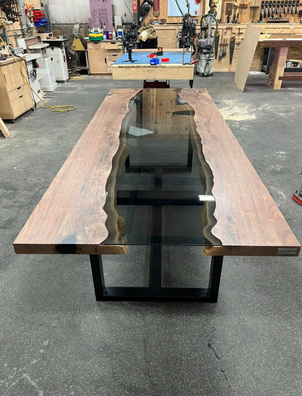 A long wooden table with a glass center in a workshop.