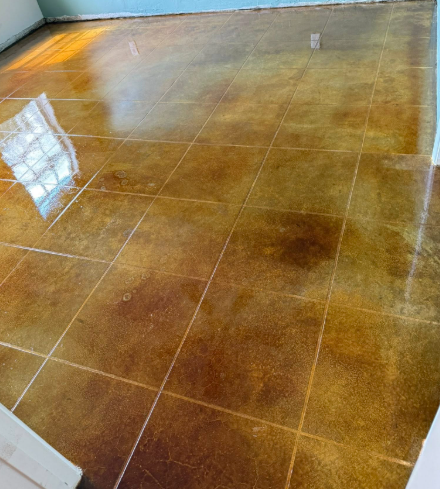 Brown and gold tiled floor reflecting light. Lines define the tile squares.