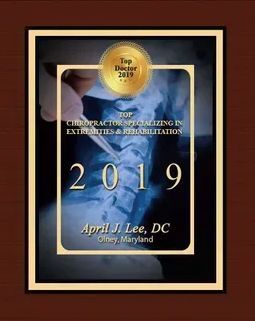 A picture of a plaque that says `` top chiropractor specializing in extremities & rehabilitation ''.