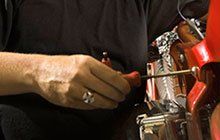 A mechanic repairing an engine.