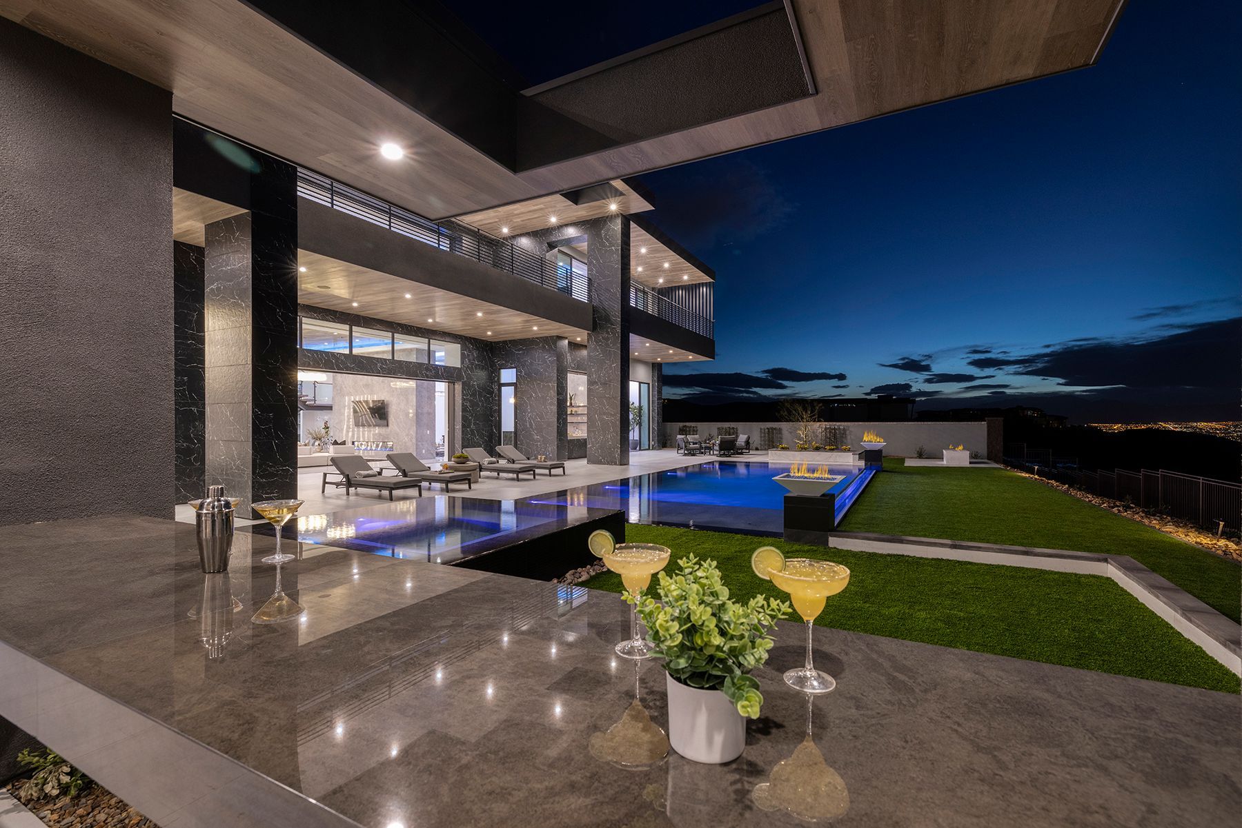 A large house with a swimming pool and a bar in front of it.