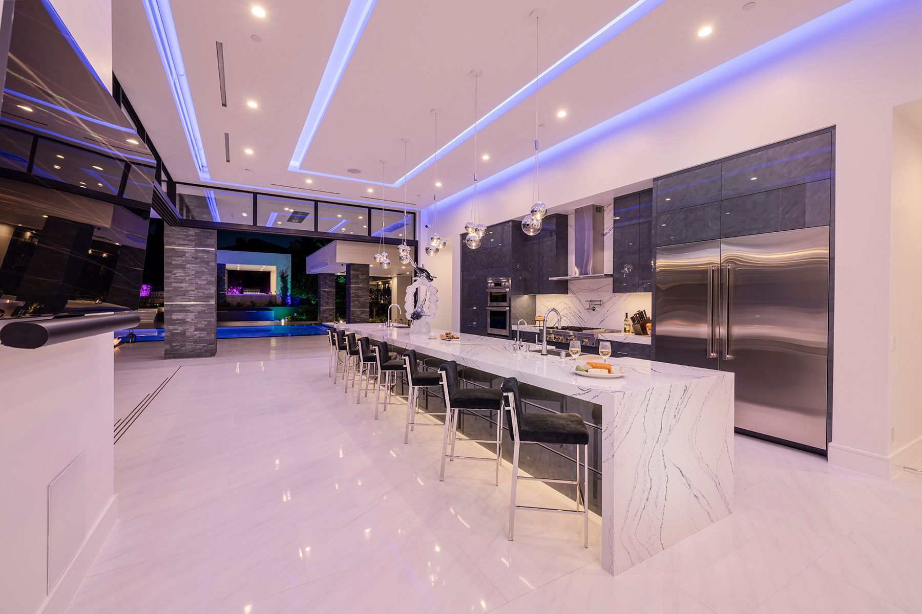 A large kitchen with stainless steel appliances and a long island.