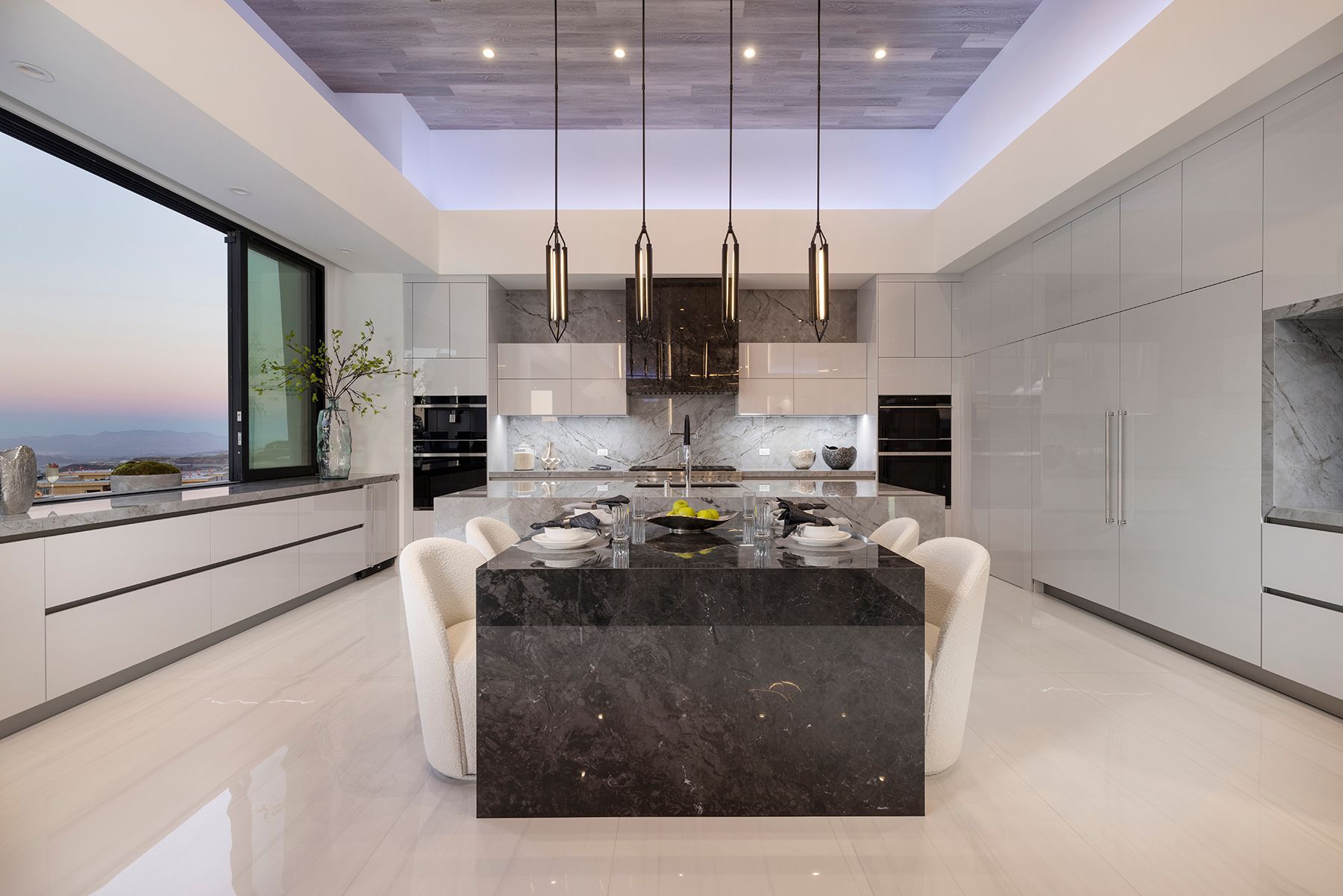 a kitchen with a large island and a dining table