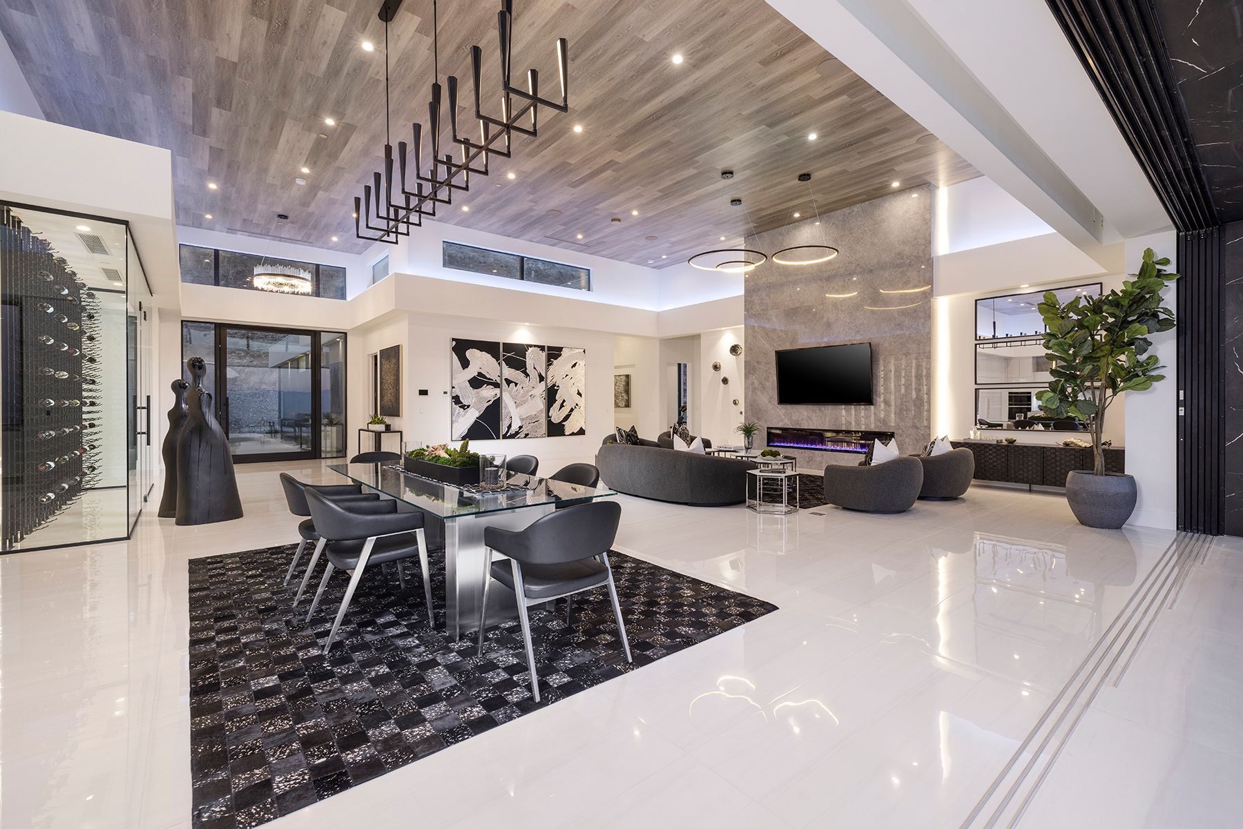 a large living room with a dining table and chairs and a television