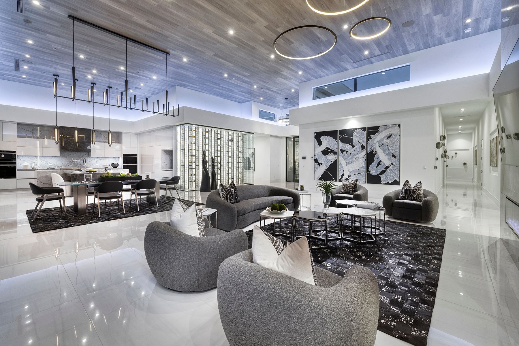 a living room with a couch, chairs, and a rug