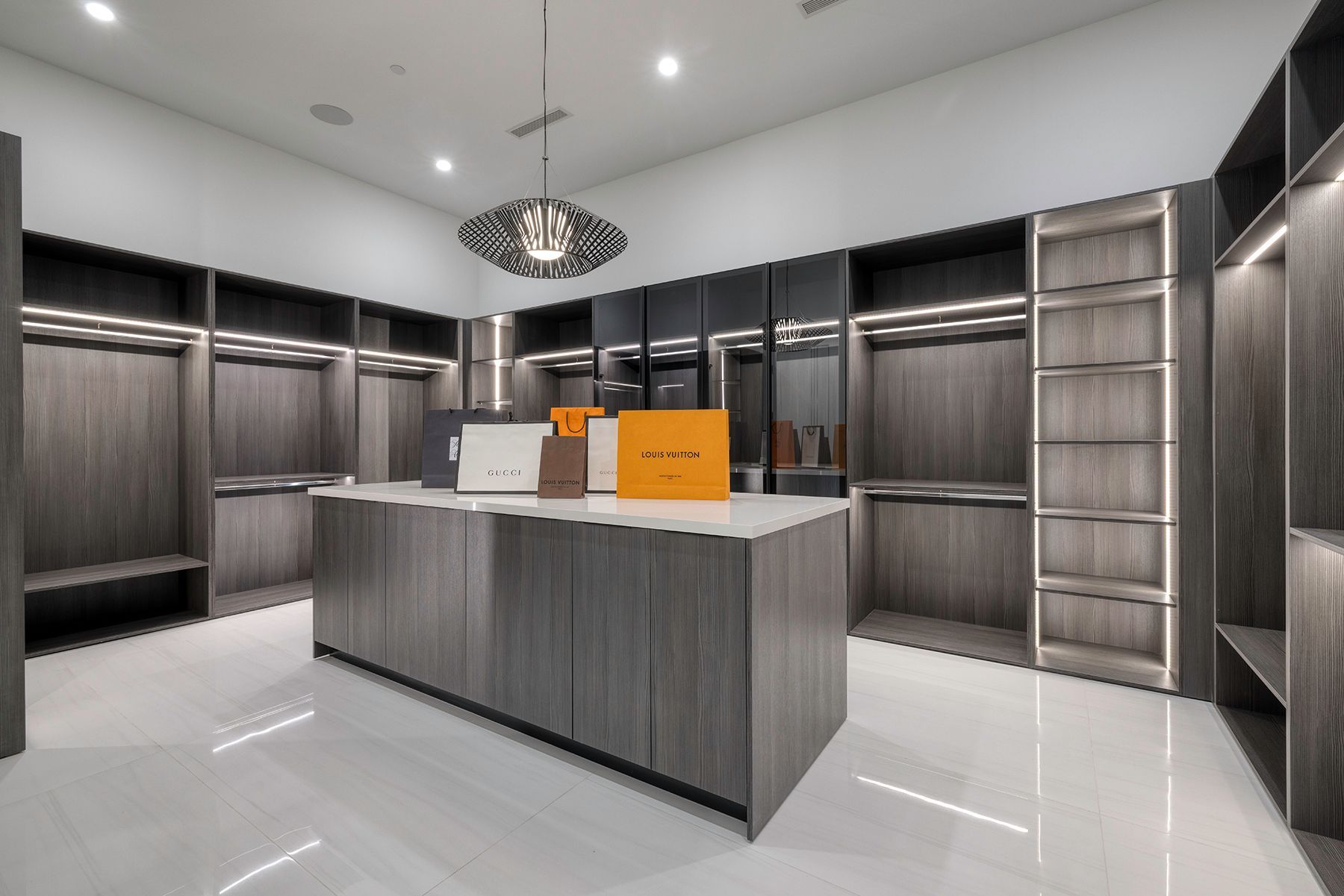 a large walk-in closet with a large island in the middle