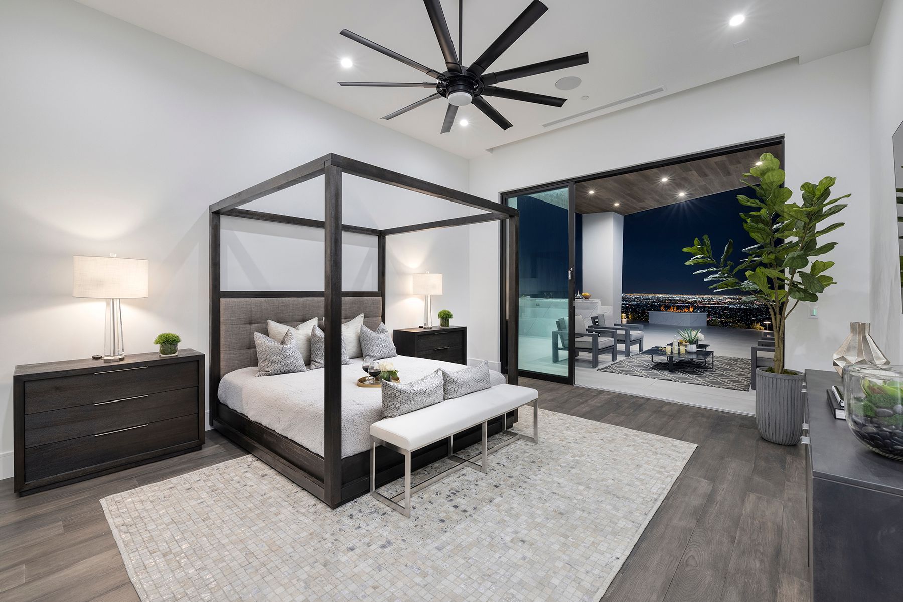 a bedroom with a canopy bed and a ceiling fan
