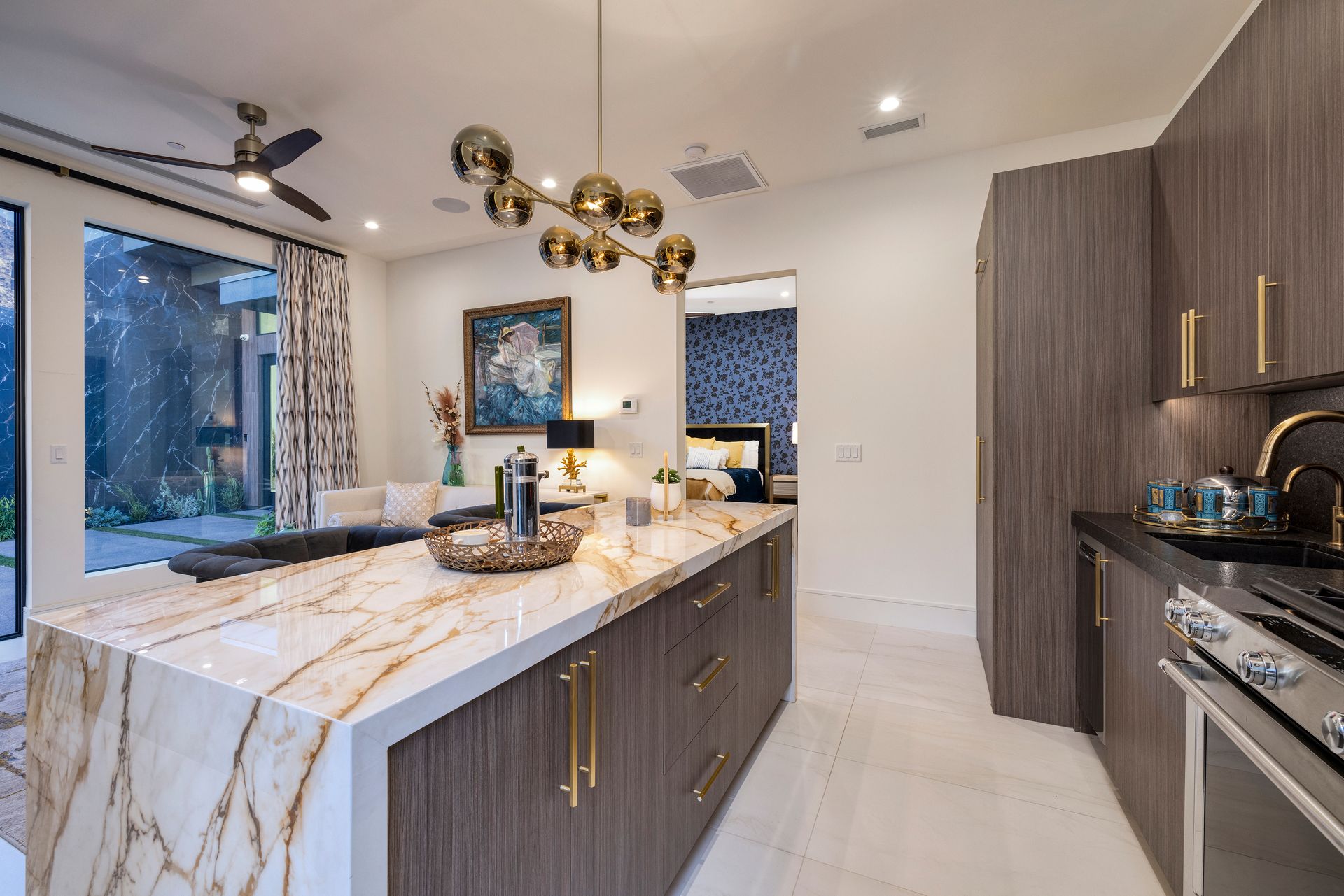 a kitchen with a marble countertop and a large ceiling fan