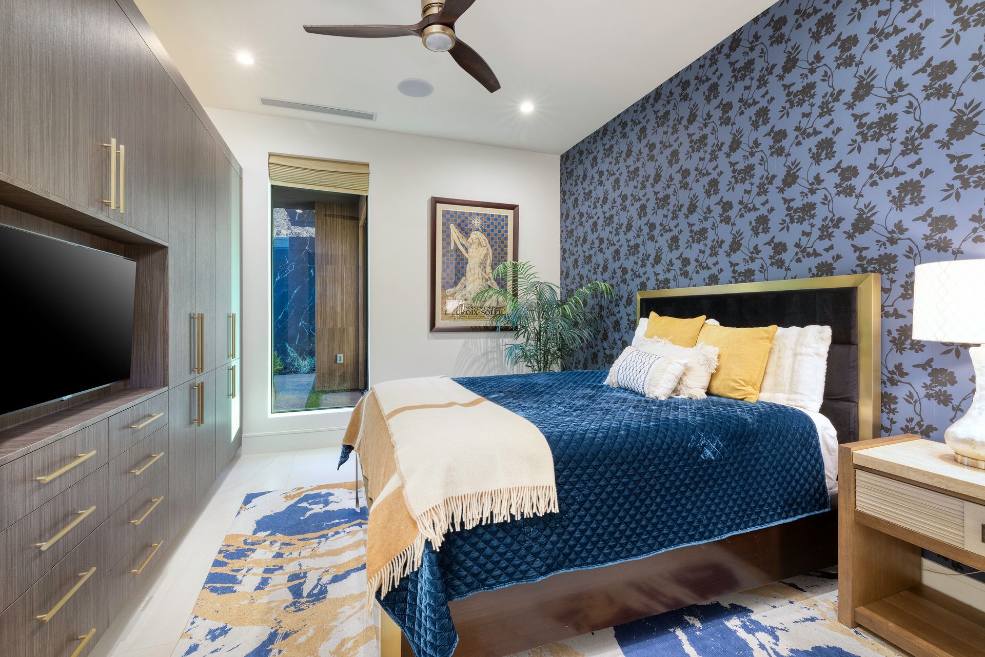 a bedroom with a bed and a ceiling fan