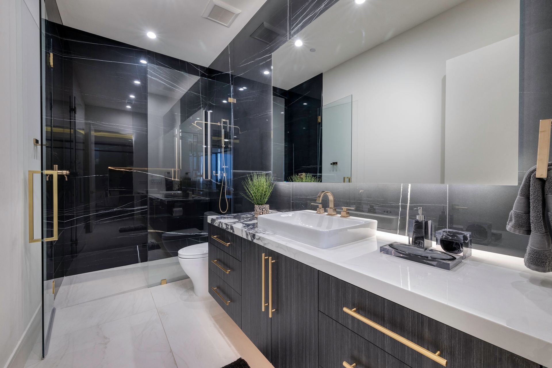 a bathroom with a sink and a glass shower
