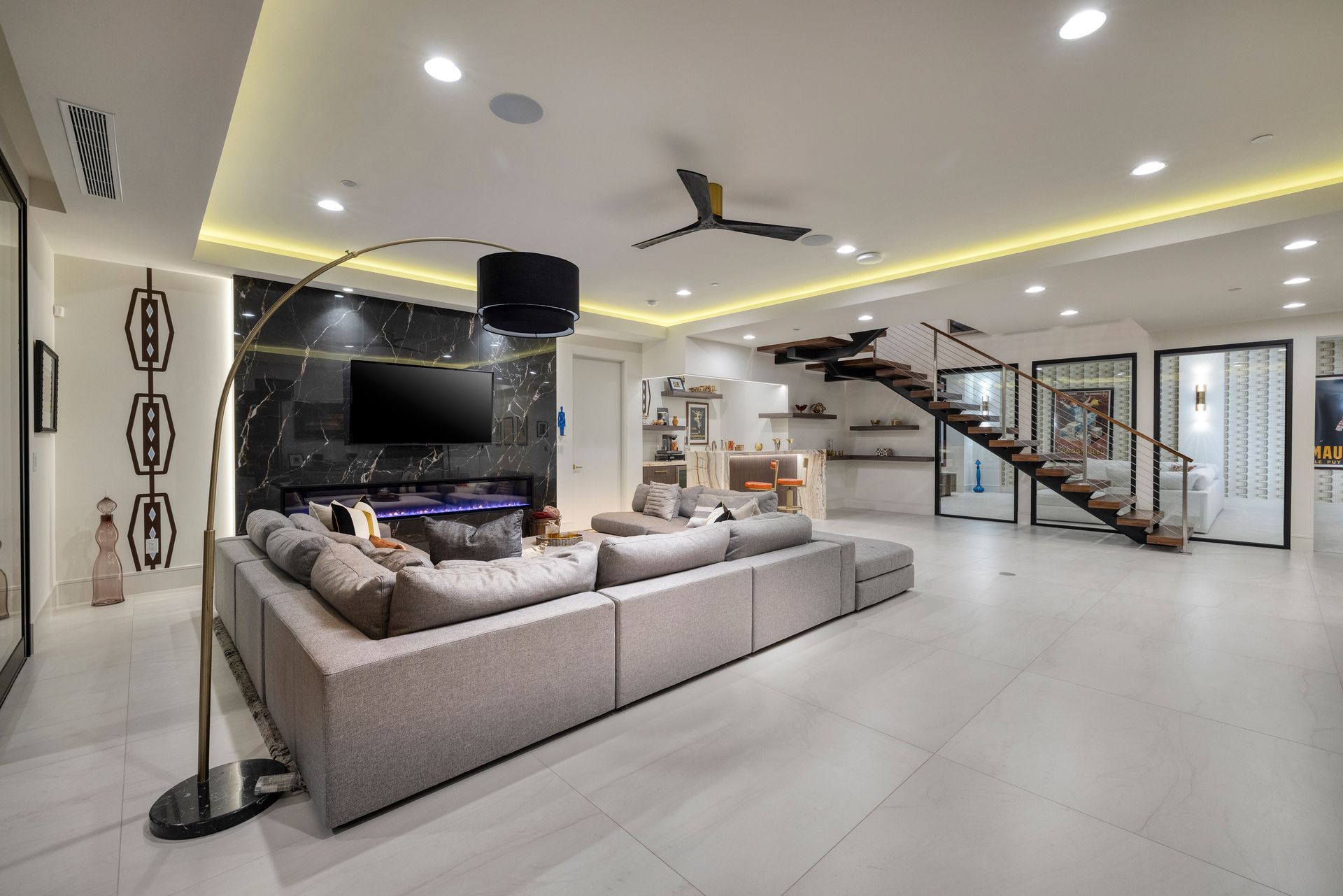 a living room with a large couch and a staircase