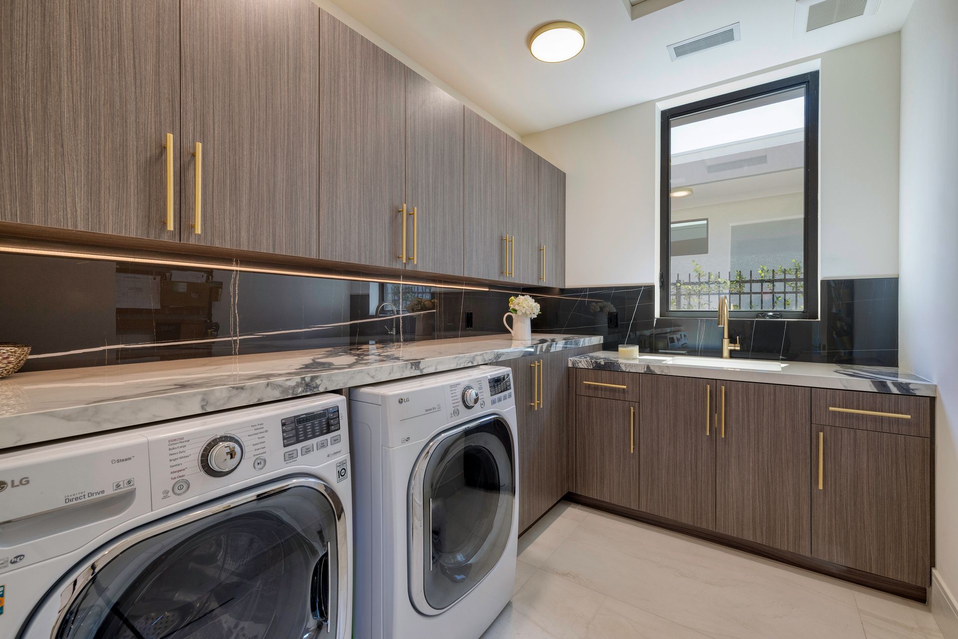 a laundry room with a washer dryer and cabinets