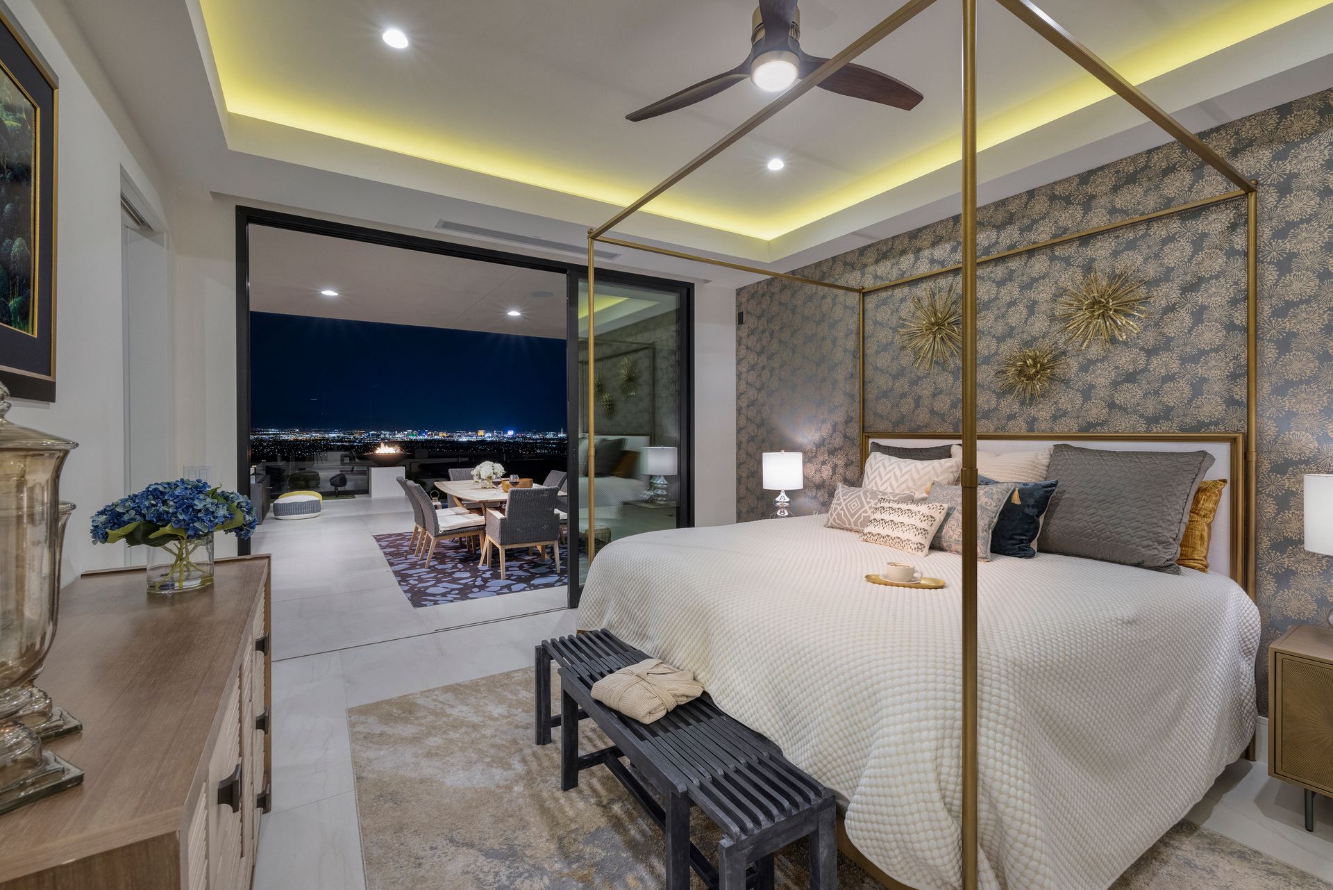 a bedroom with a large bed and a ceiling fan