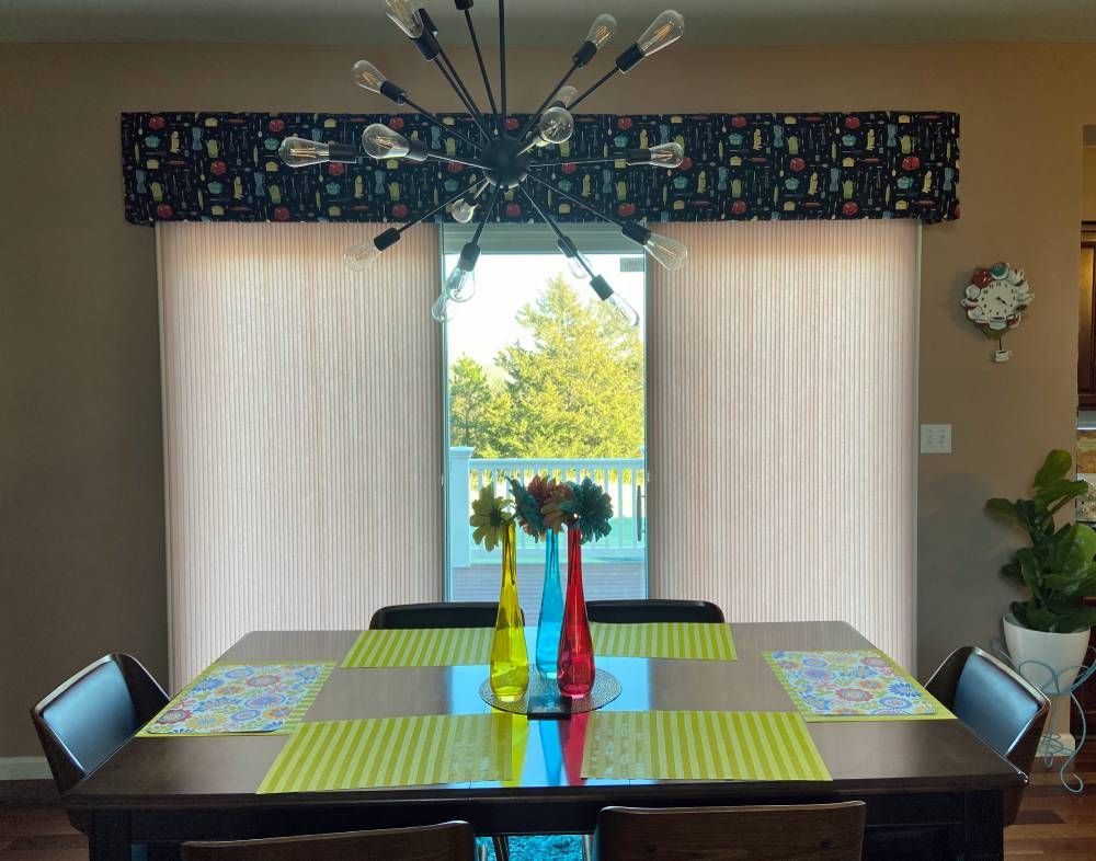 A dining room table with a vase of flowers on it