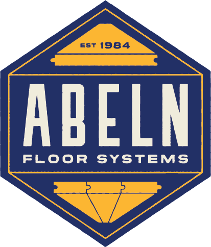 A person in a white uniform uses a stethoscope to examine a patient lying in a hospital bed.