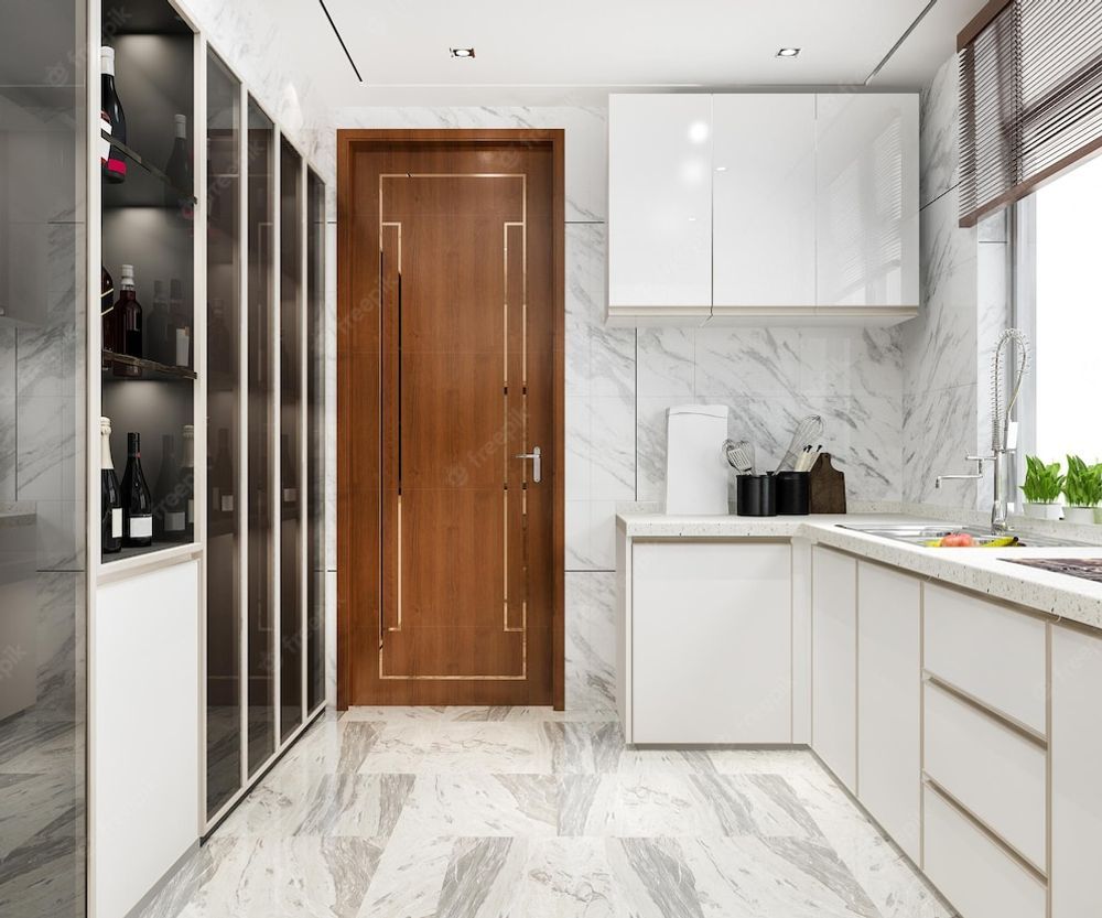 A modern kitchen featuring white cabinets, marble floors and walls, a wine display, and a central wooden door.