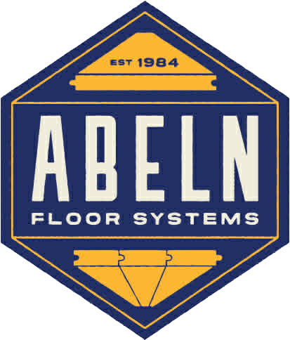 A person in a white uniform uses a stethoscope to examine a patient lying in a hospital bed.