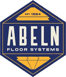 A white rectangular sign with rounded black corners, featuring the black text "ABELN FLOOR SYSTEMS" in bold, sans-serif font.