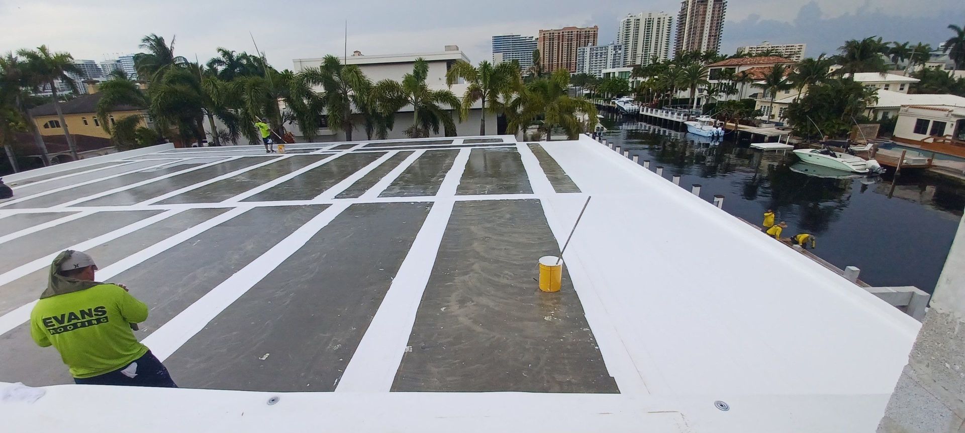 A man is sitting on the roof of a building.