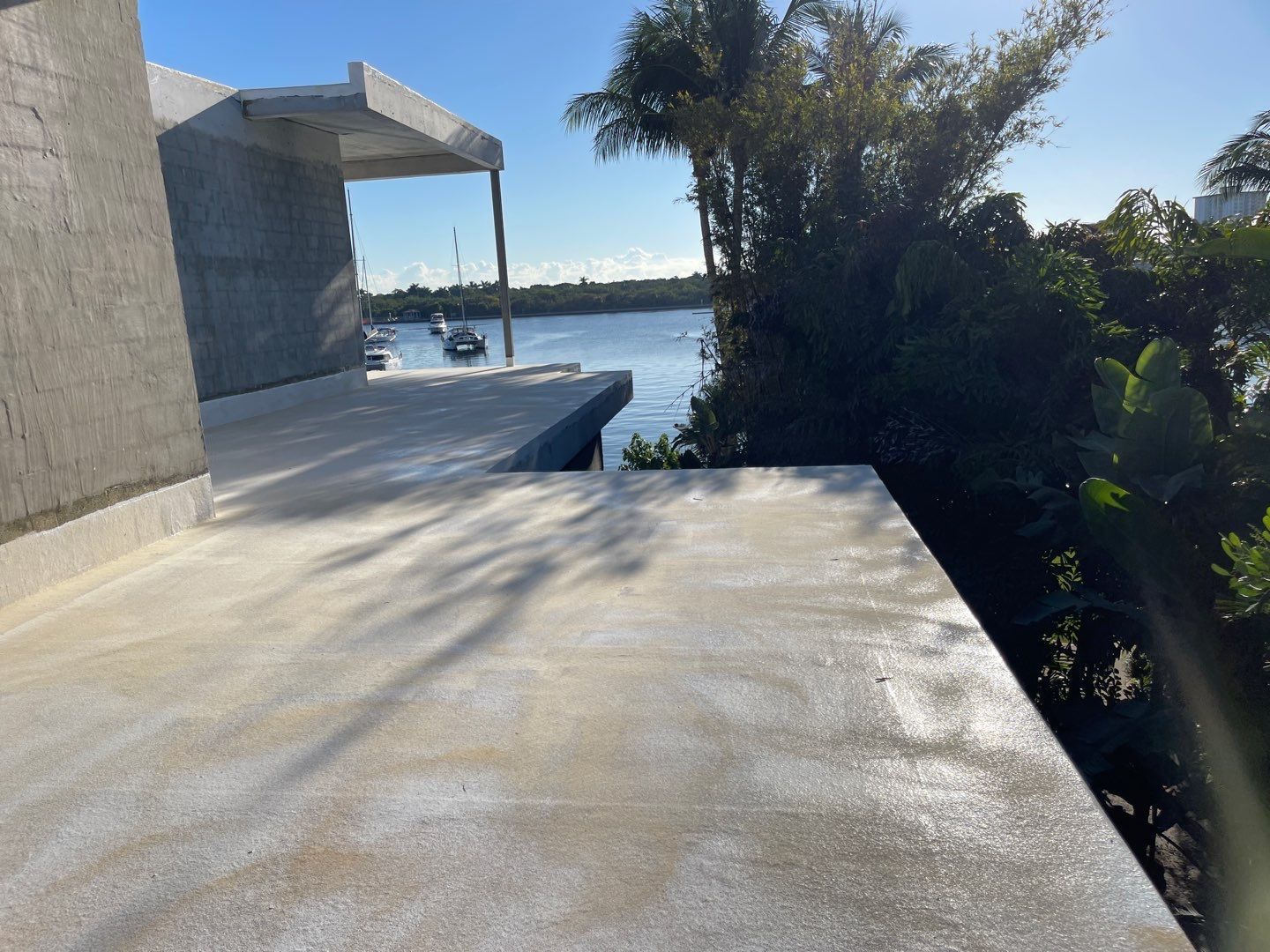A concrete deck with a view of a body of water.