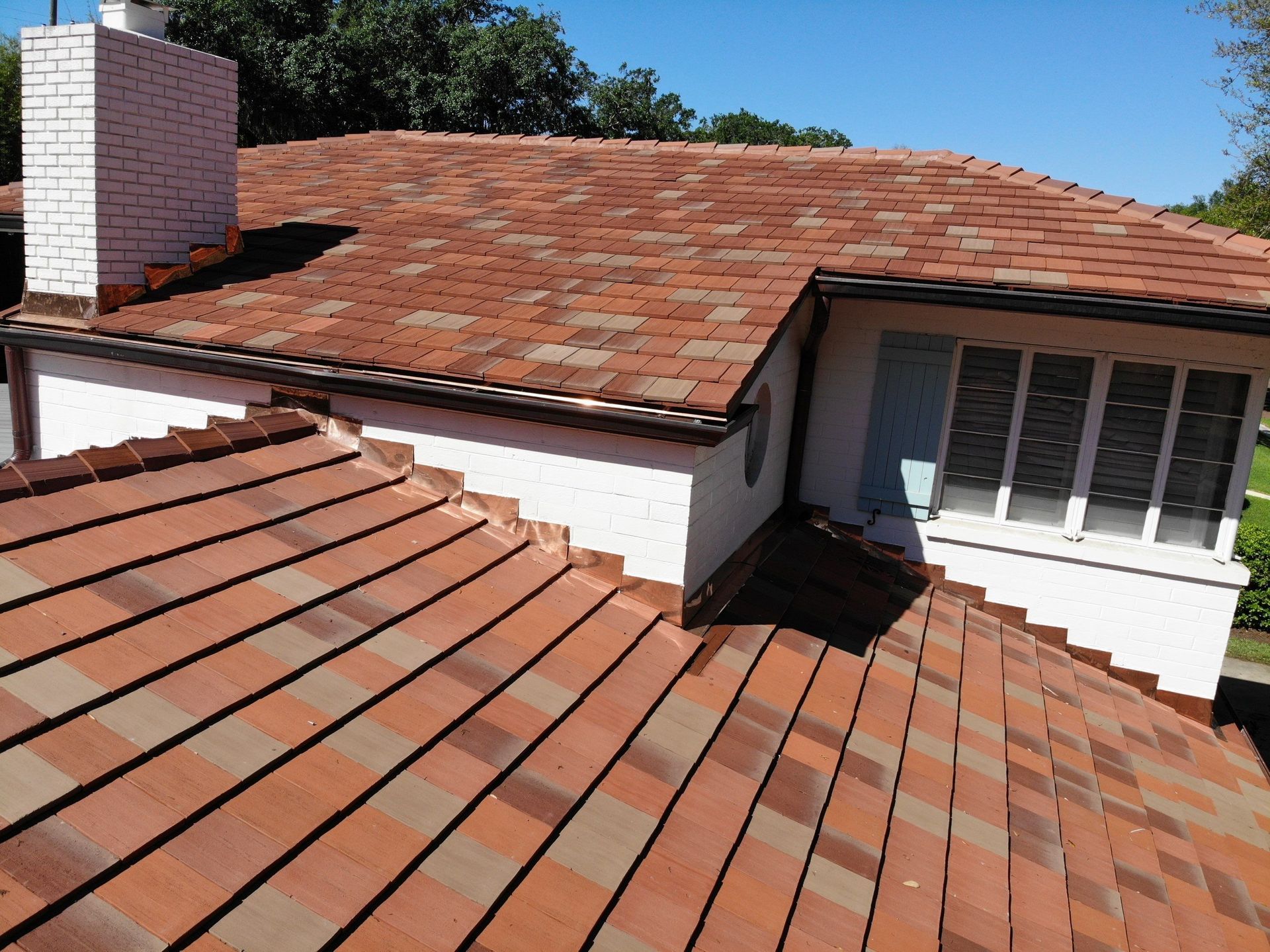 A house with a red tiled roof and a chimney