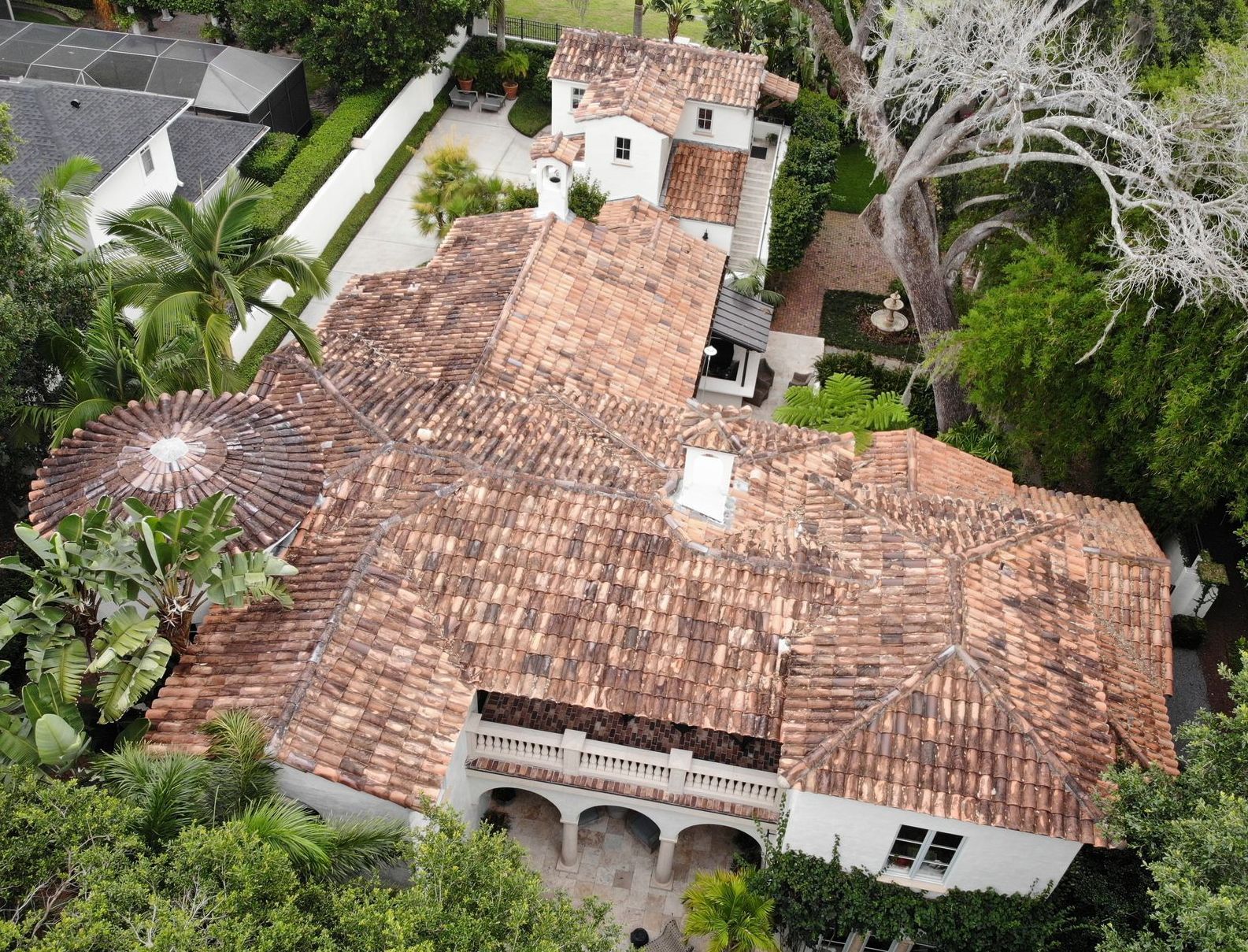 An aerial view of a large house with a tiled roof