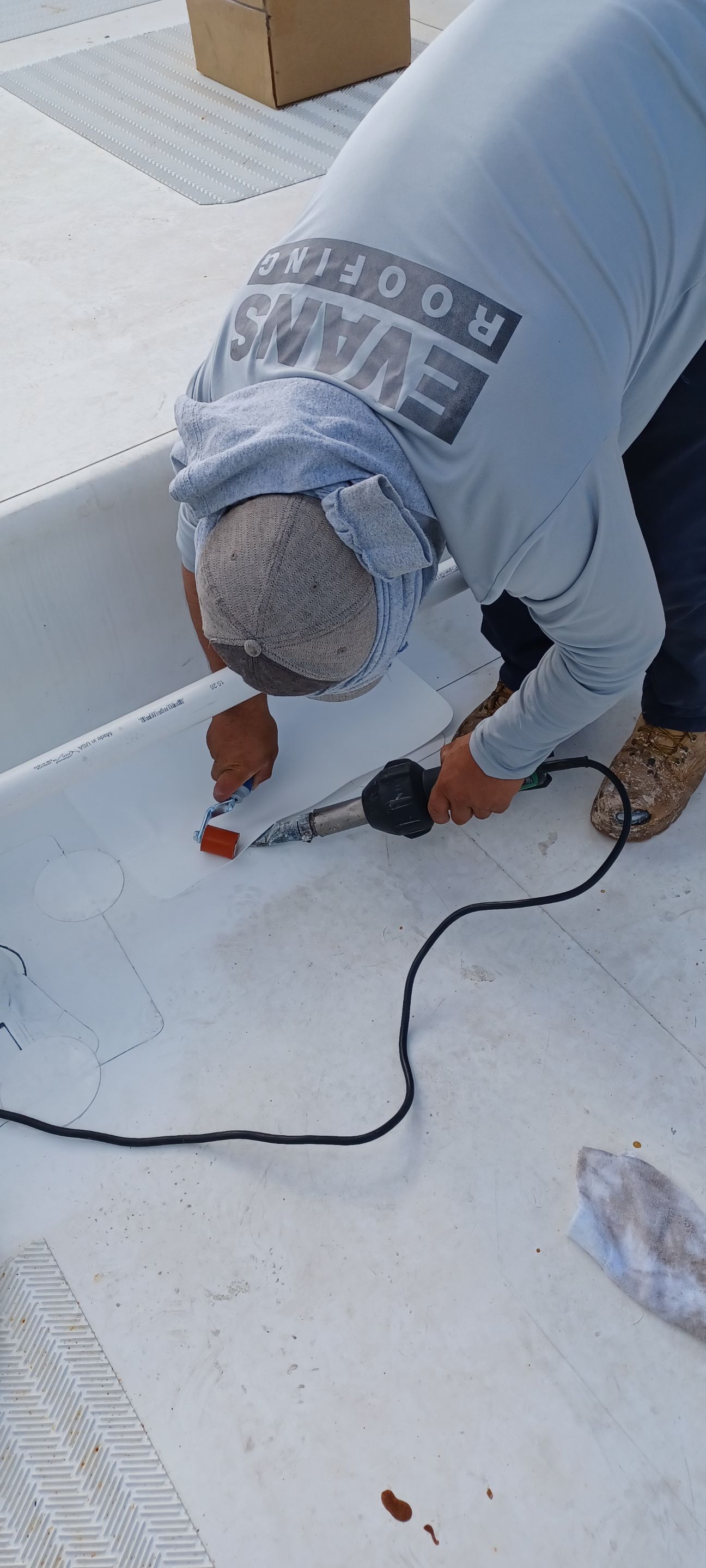 A man is working on a boat with a drill.