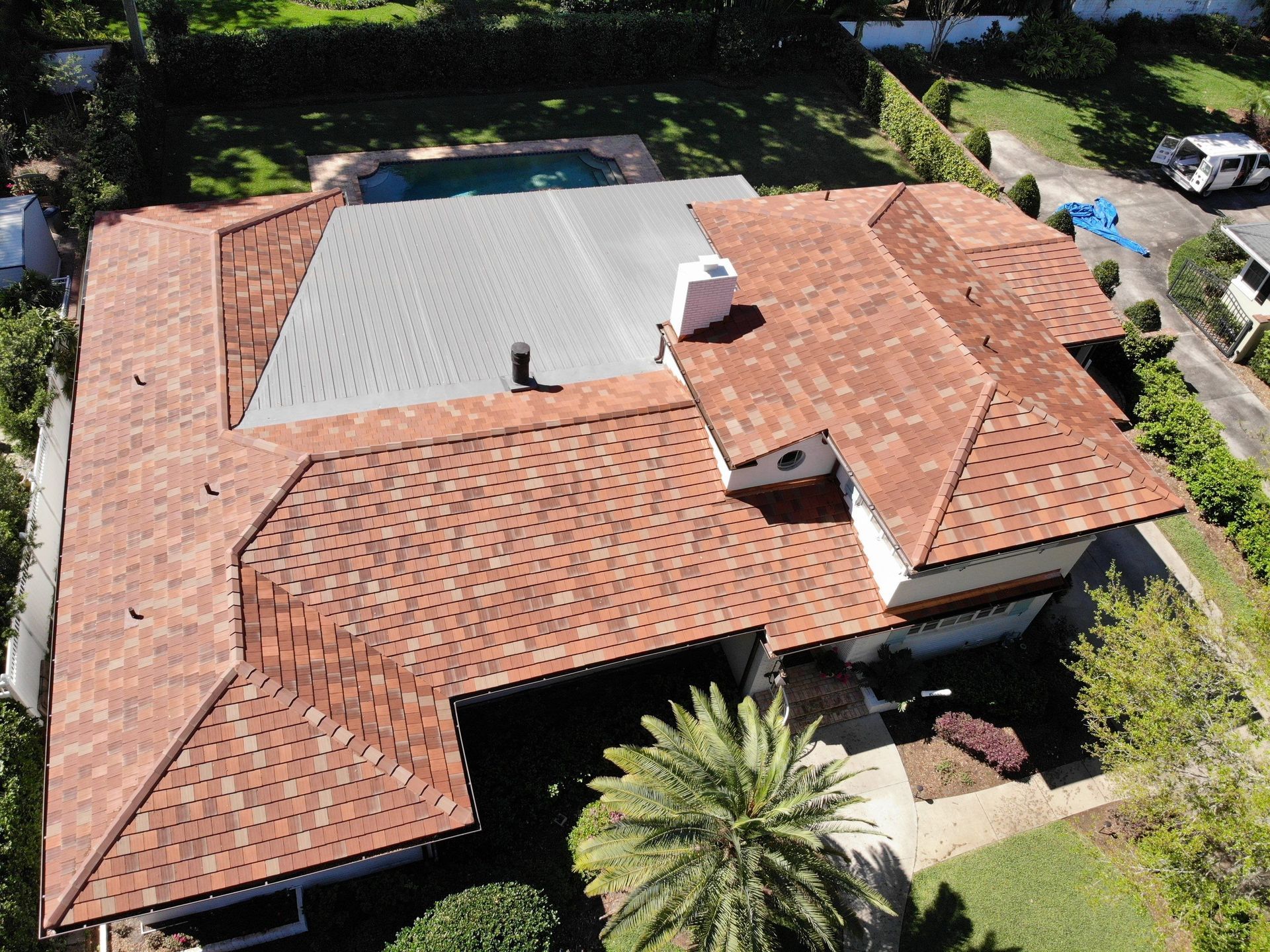 An aerial view of a house with a red tiled roof