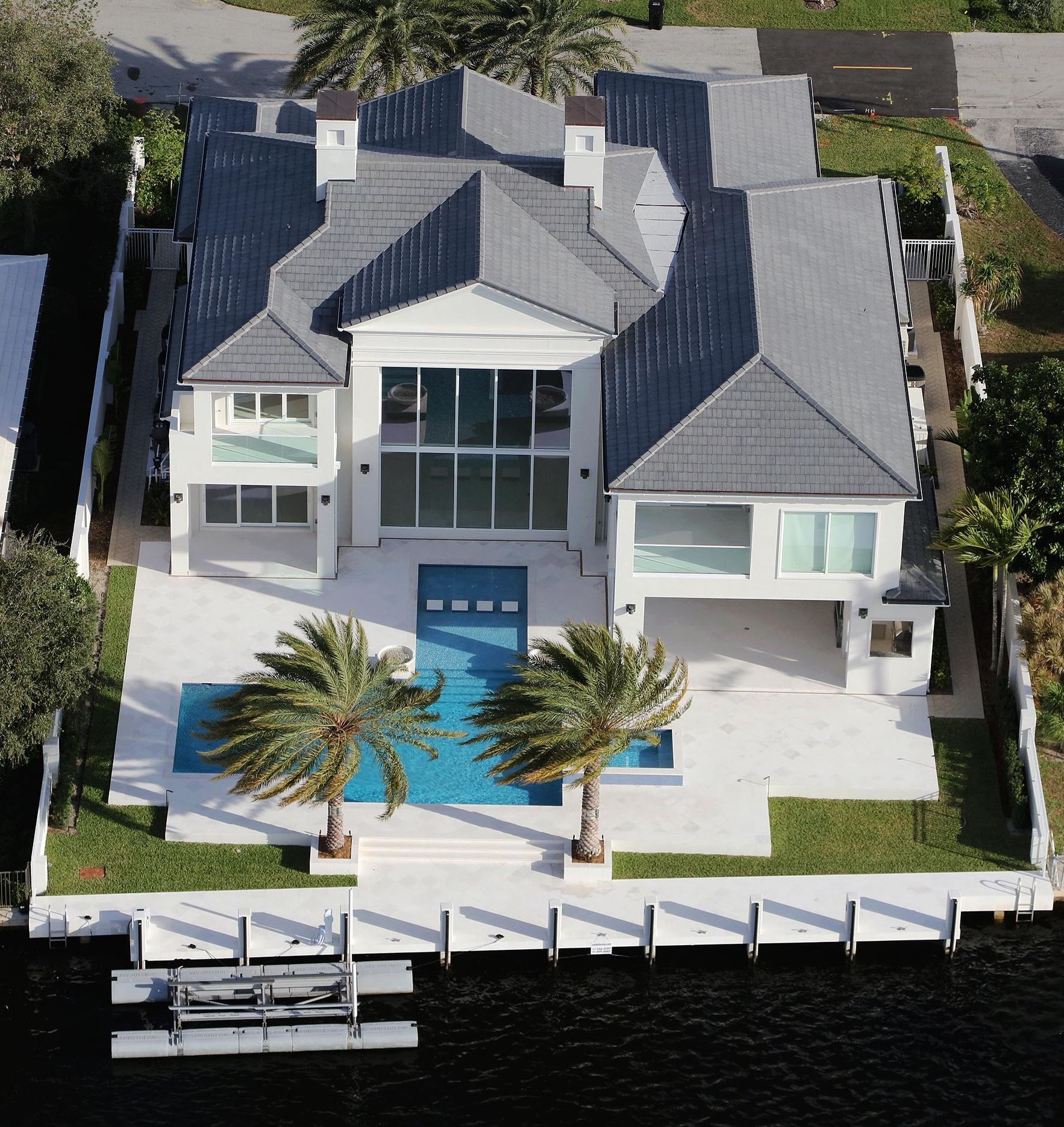 An aerial view of a large house with a swimming pool